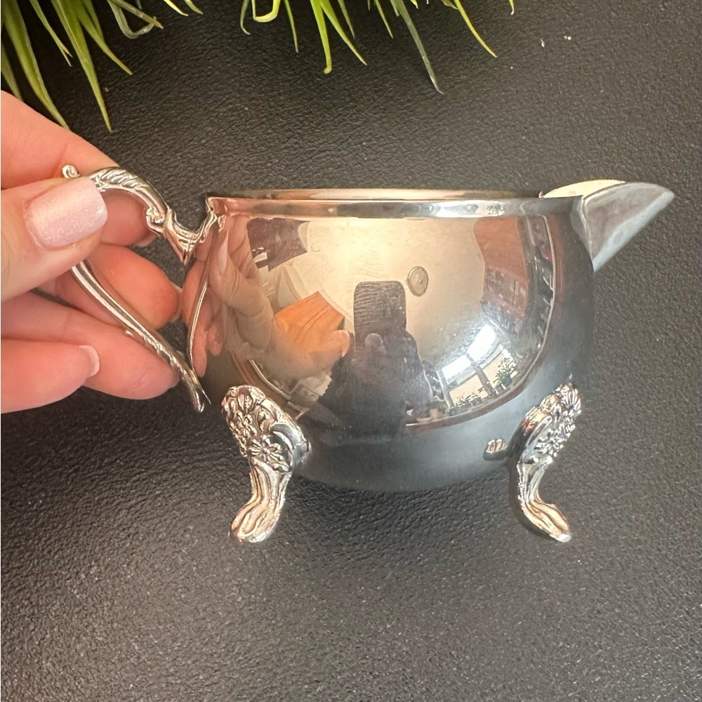Elegant Silver Creamer with Ornate Handle